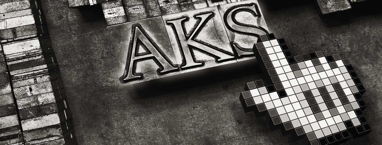 Masthead Graphic: 3-dimensional hyperlink cursor hovering over glowing ‘AKS’ letters arranged in 60 point Monotype Centaur metal type sorts for handset letterpress printing.