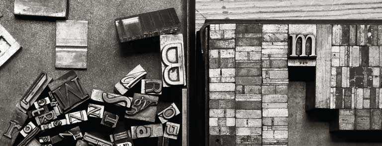 Graphic: On the left, a variety of metal type sorts for handset letterpress printing in a resorting tray; on the right, a tray of various metal quads.